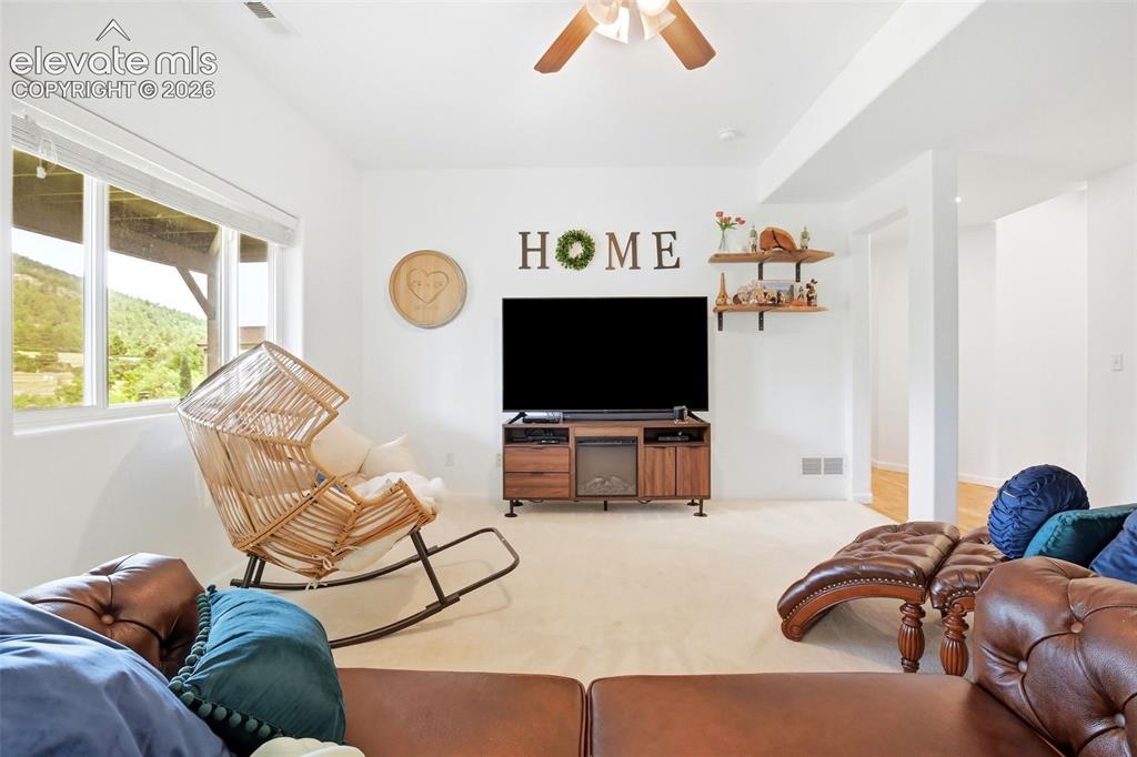 Image 43 of 49: Recessed lighting, ceiling fan, carpet flooring, large window, and built-in