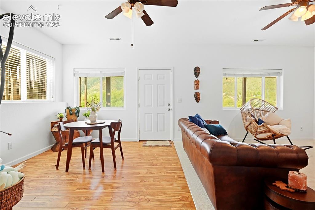 Image 44 of 49: Bright interior with light wood-finish flooring, white walls, and multiple 