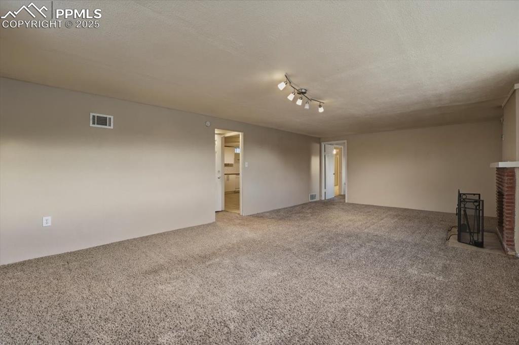 Image 24 of 42: Basement Family Room with Mountain Views