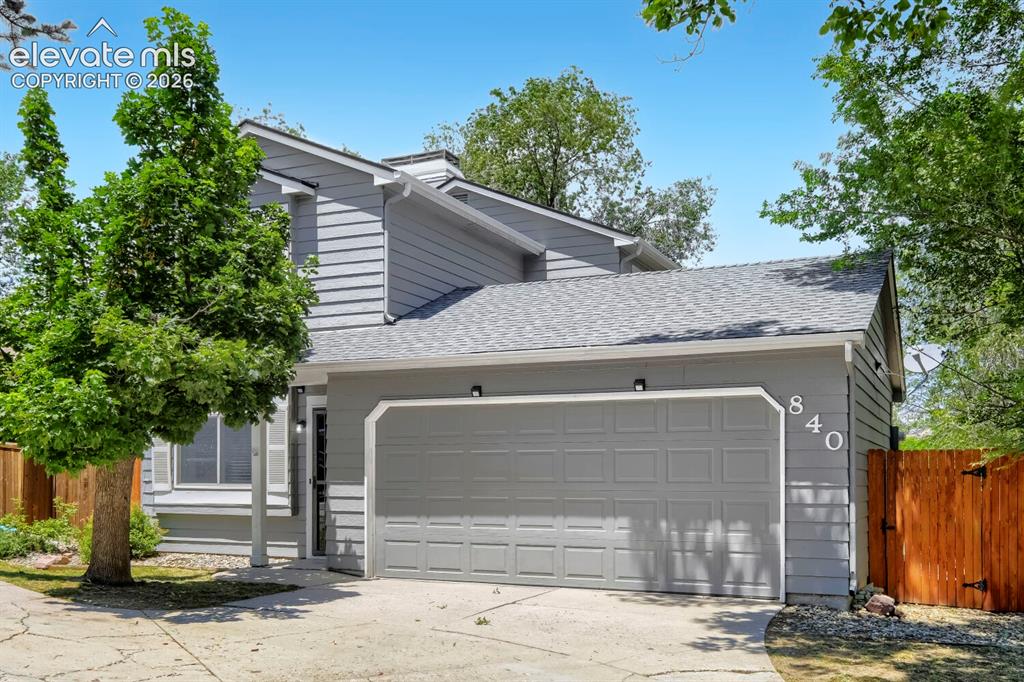 Image 1 of 28: Contemporary facade featuring gray horizontal siding and a two-car garage