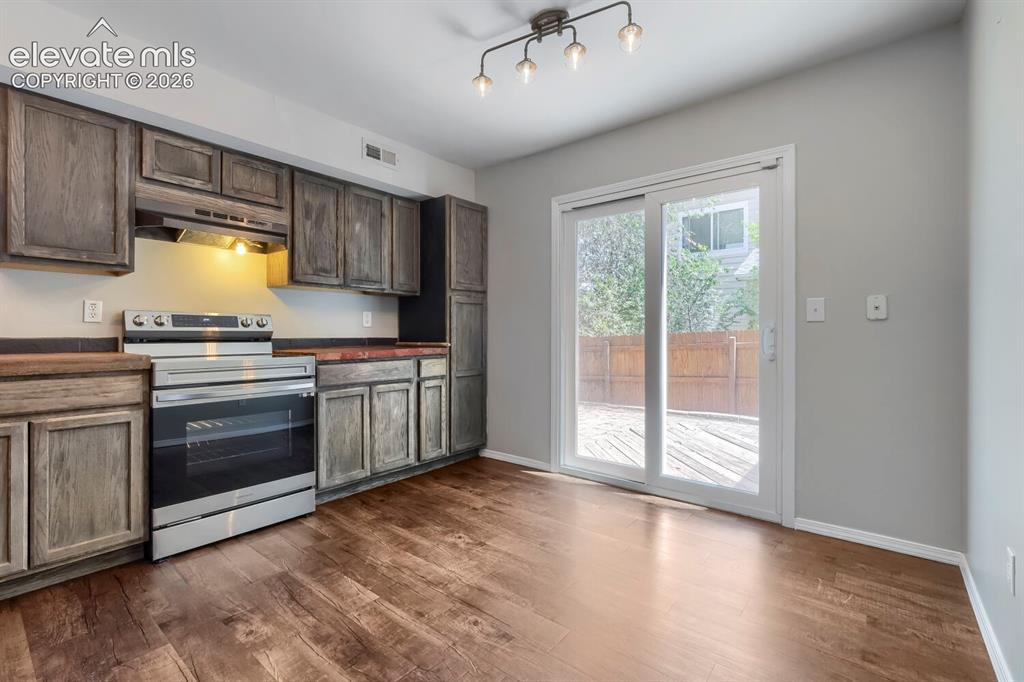 Image 6 of 28: Kitchen featuring wood-finish flooring, gray shaker-style cabinetry, and da