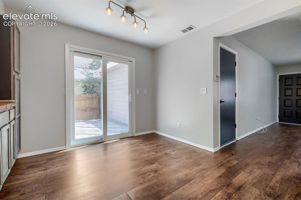 Image 9 of 28: Dining space featuring wood-finish flooring