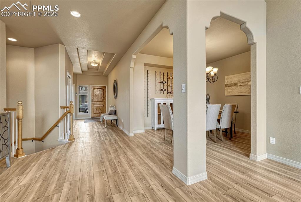 Image 10 of 50: Beautiful architectural arches guide you from the entry hallway into the ho