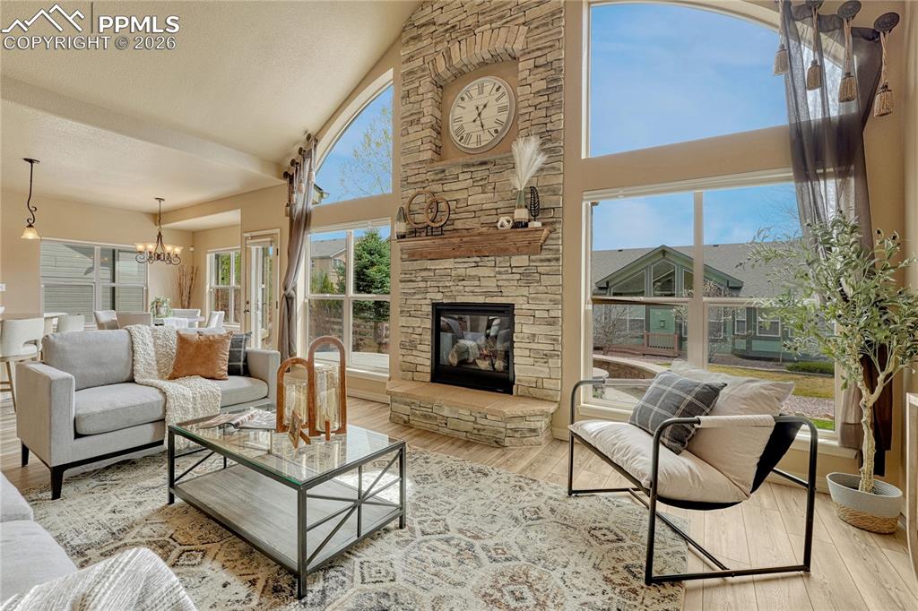Image 15 of 50: The rustic stacked stone fireplace serves as the centerpiece of the home, o