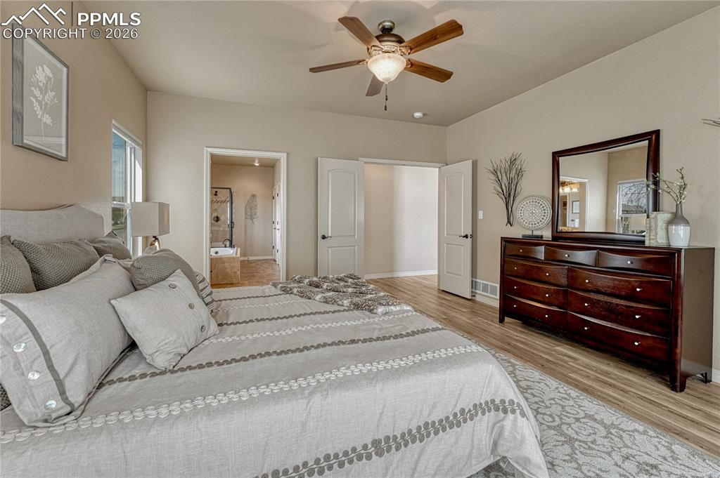 Image 26 of 50: Retreat to the expansive main-level primary bedroom, designed with a spacio