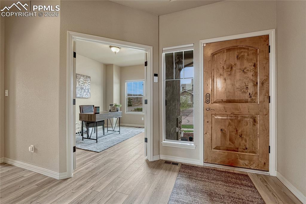 Image 3 of 50: Step inside to discover a front office through french doors and luxury plan