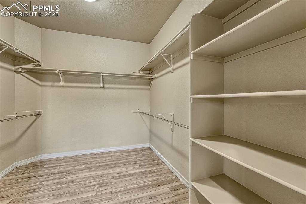 Image 31 of 50: Keep your wardrobe perfectly organized in the primary suite’s massive walk-