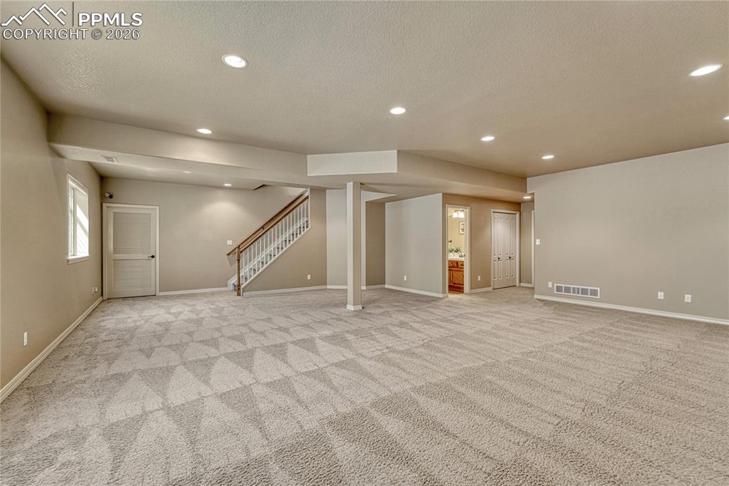 Image 33 of 50: Discover a massive finished basement complete with 9-foot ceilings, offerin
