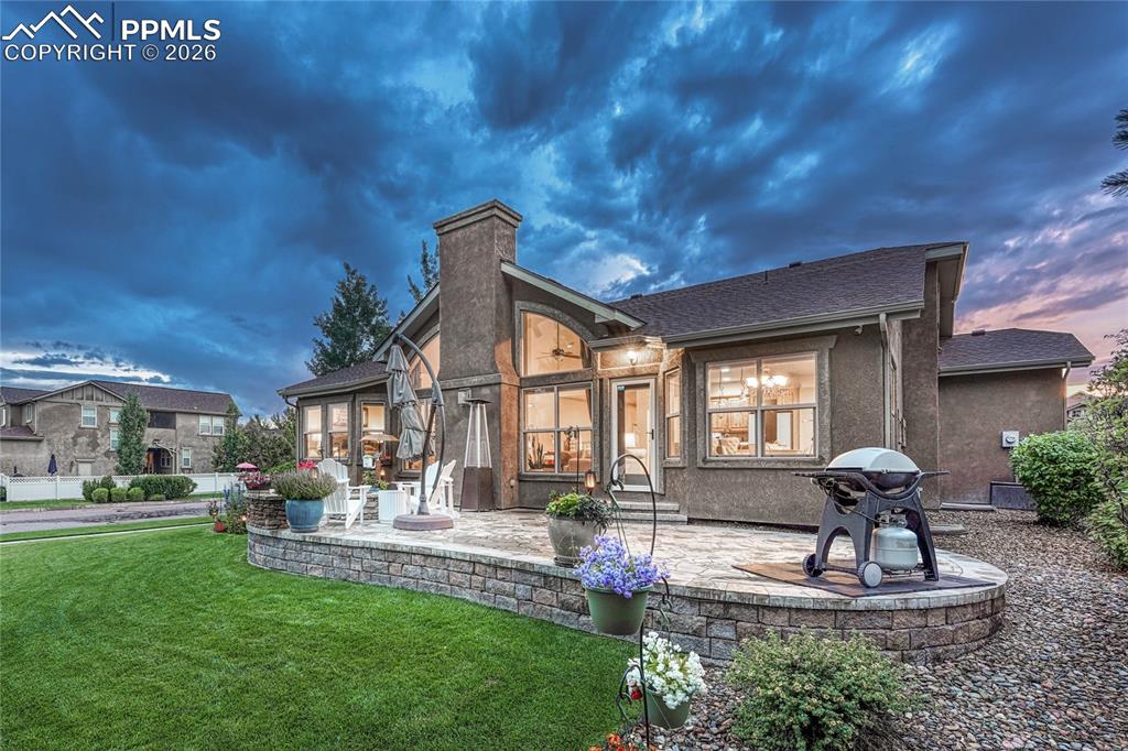 Image 39 of 50: Step outside to your personal oasis featuring a custom stone patio, ideal f