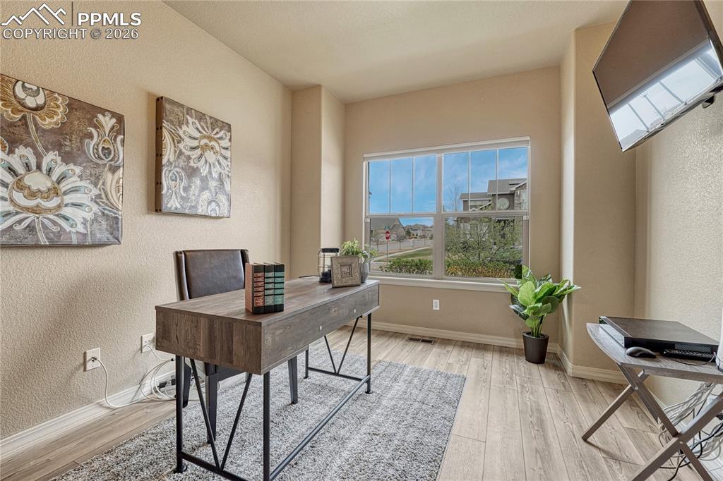 Image 4 of 50: A dedicated main-level office provides the perfect quiet retreat for remote