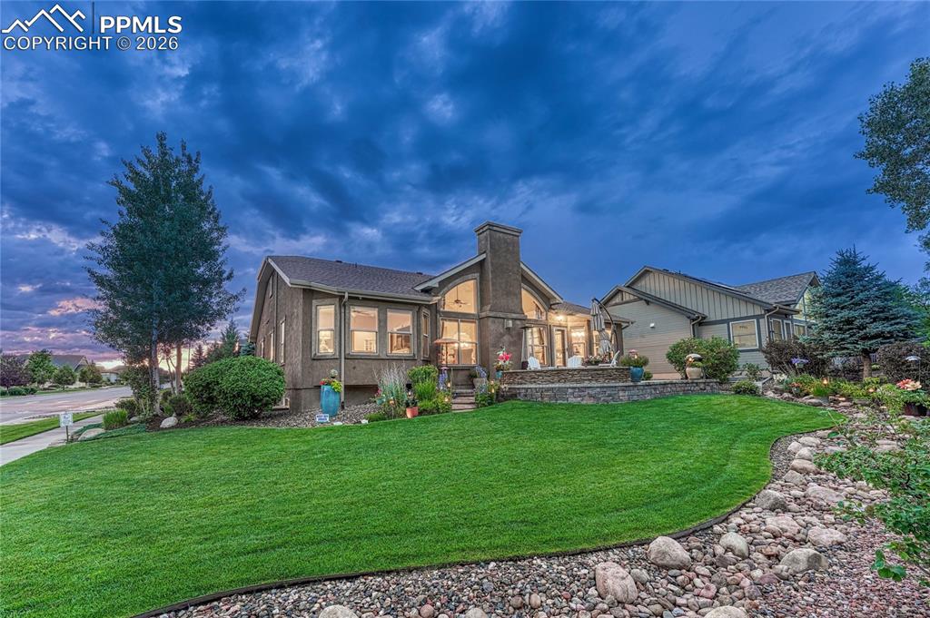 Image 44 of 50: This incredible home truly shines at dusk, showcasing its stunning architec