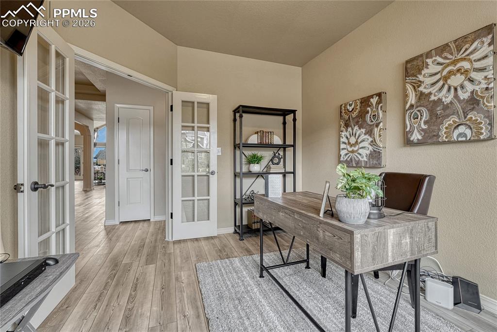 Image 5 of 50: Elegant French doors enclose the home office, blending modern appeal with c