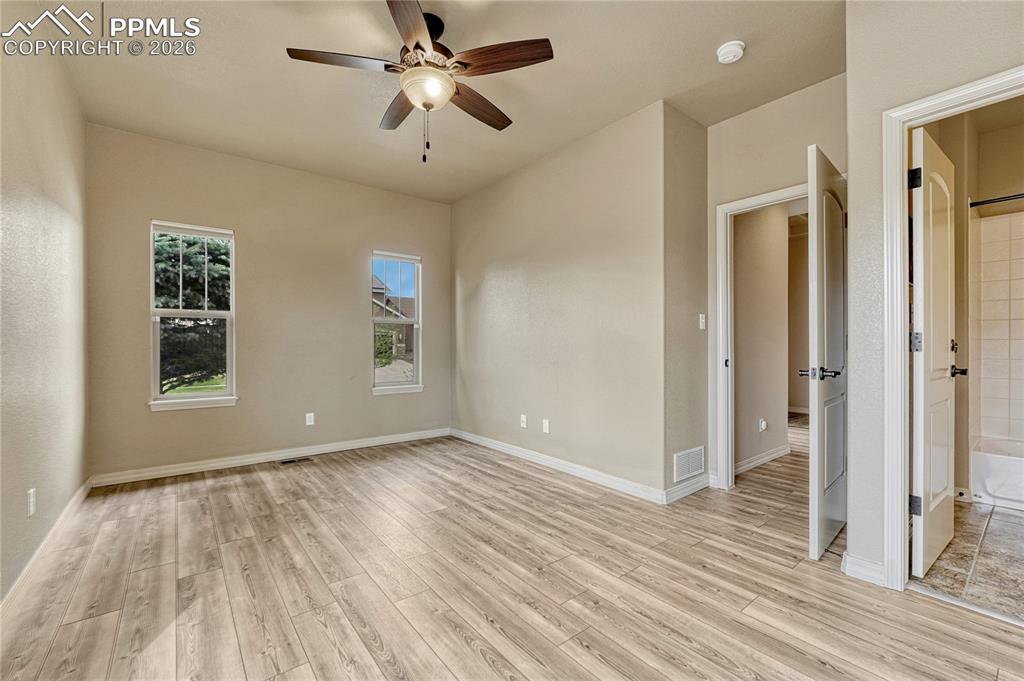 Image 7 of 50: A spacious main-level bedroom serves as a wonderful junior suite, complete 