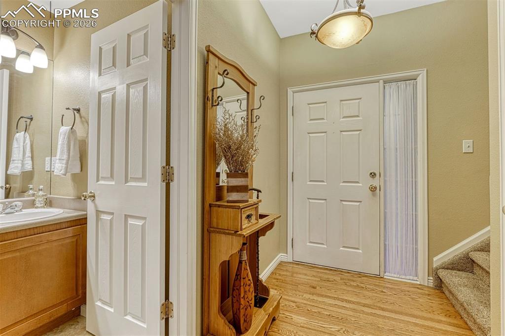 Image 23 of 46: Beautiful entry with half bath and when your guests step through the front 