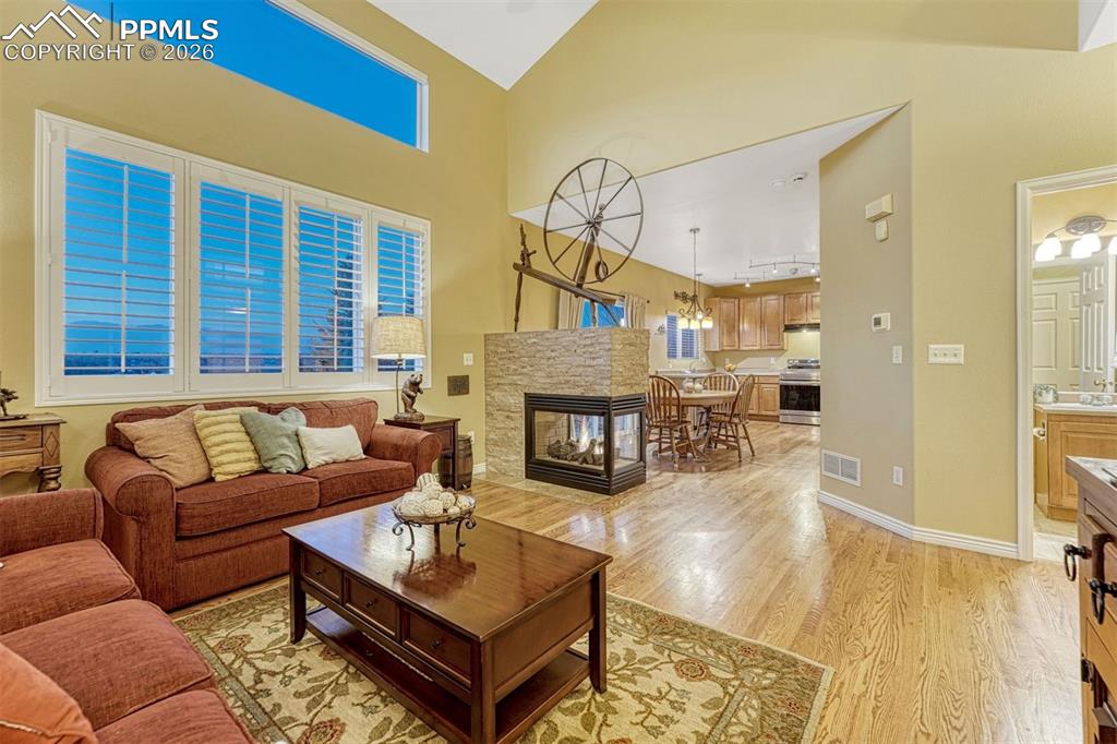 Image 24 of 46: Mountain views, cozy fireplace warms the main level and is open and airy