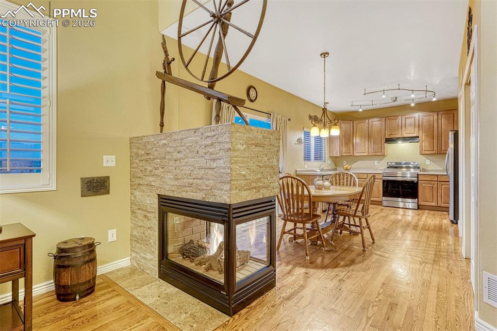 Image 3 of 46: Fireplace warms the living, dining and entry