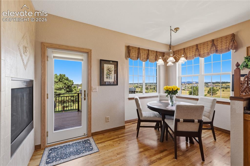 Image 21 of 49: Bay windows with expansive outdoor scenery, wood-finish flooring, built-in 