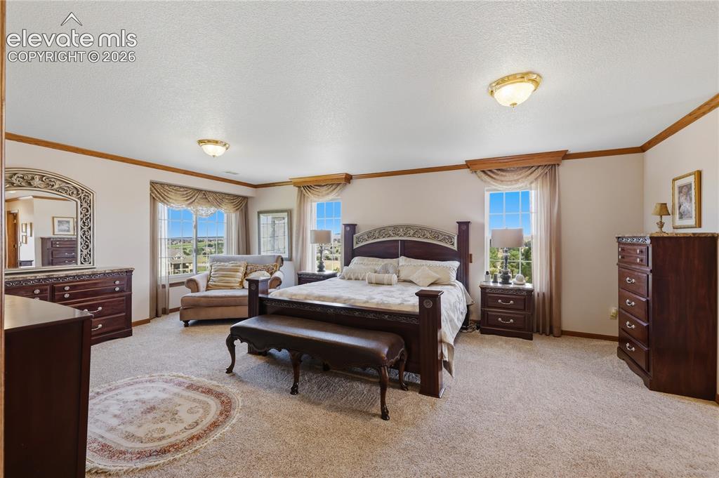 Image 24 of 49: Neutral color palette, decorative trim, recessed window, and flush mount li
