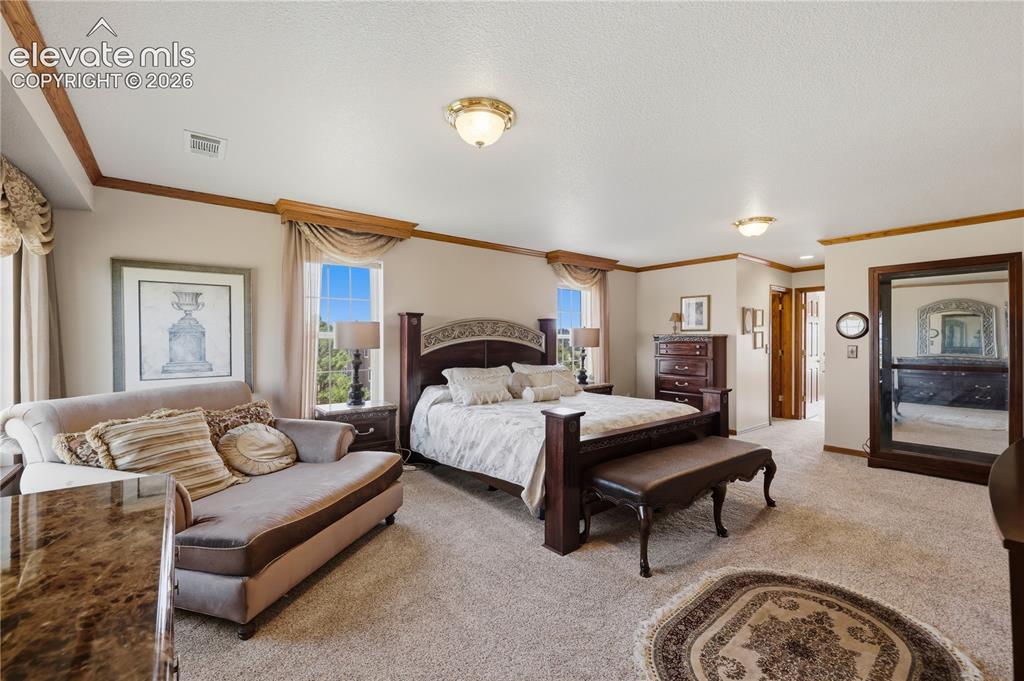 Image 25 of 49: Carpeted room with high ceilings, recessed lighting, and crown molding