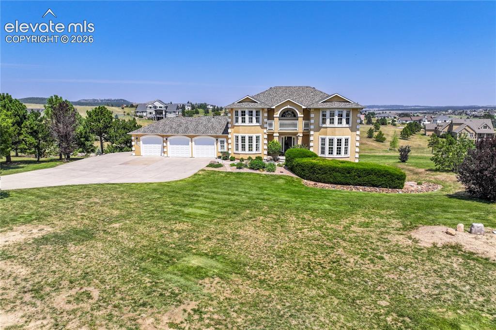 Image 3 of 49: Elegant two-story residence showcasing a domed architectural entry, multi-p