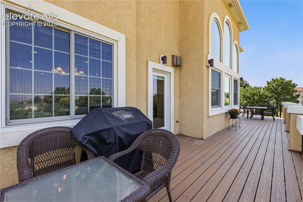 Image 41 of 49: Expansive composite deck featuring composite wood-finish flooring, wicker s
