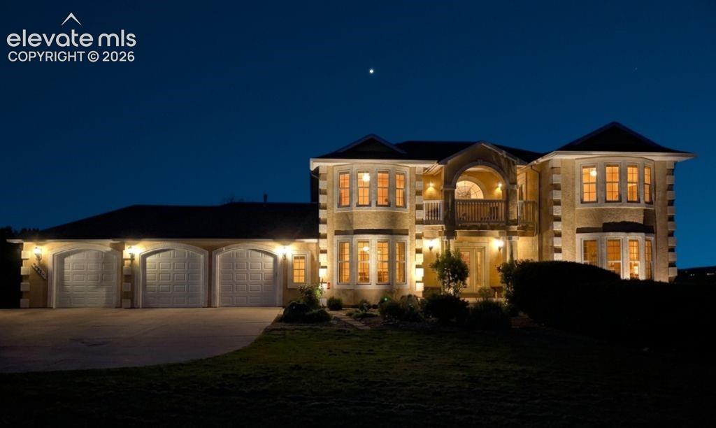 Image 45 of 49: Stucco exterior with stone-look accents and multiple bay windows