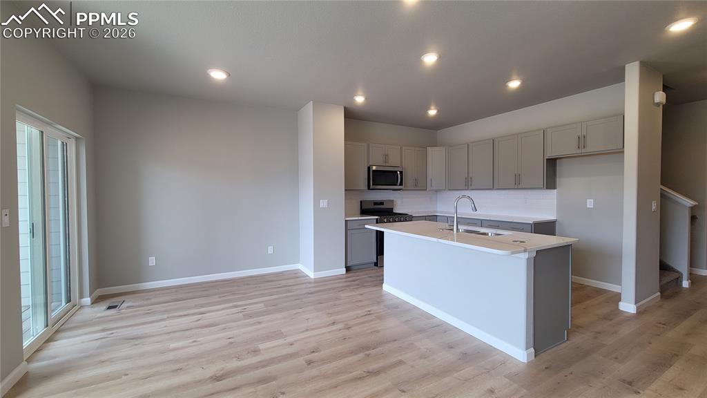 Image 10 of 36: Dining area with LVP flooring, and walks out to covered composite deck! 