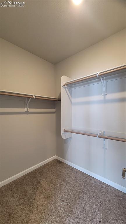 Image 19 of 36: Primary Closet with wood shelving and rods! 