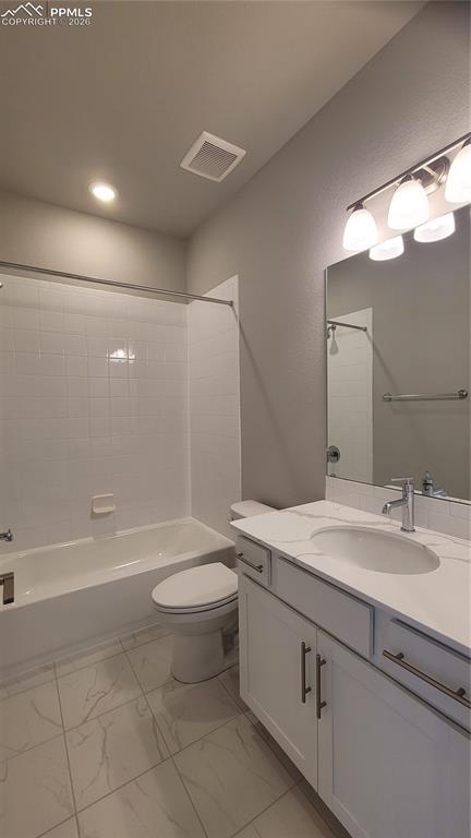 Image 26 of 36: Full Bathroom, located on upper level with quartz countertop and tile surro