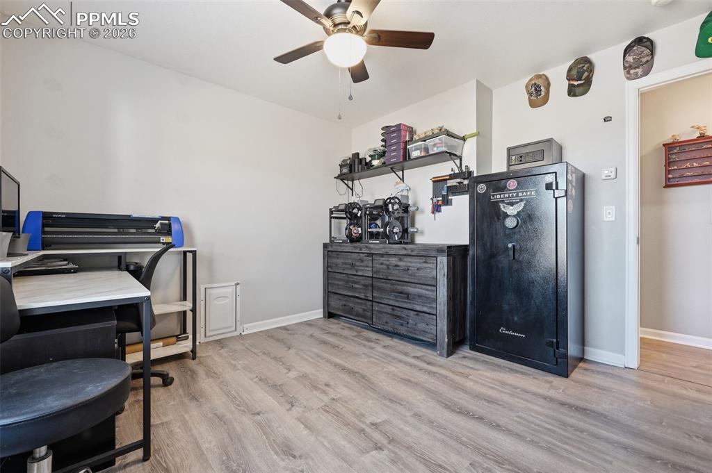 Image 14 of 28: Room featuring wood-finish flooring, light grey wall paint, and a ceiling f