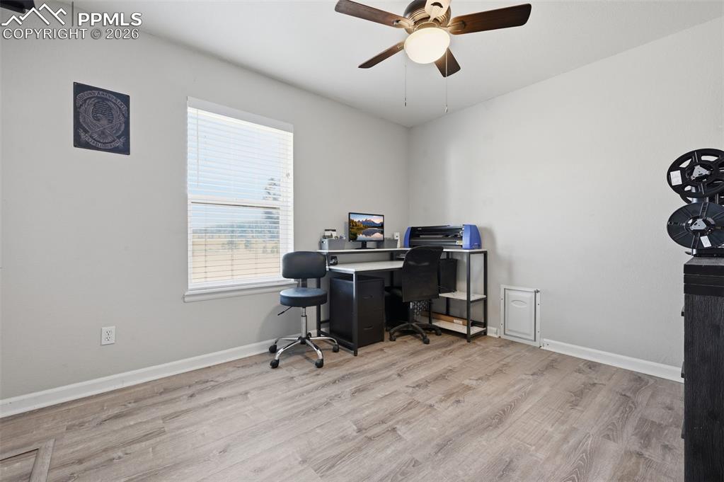 Image 15 of 28: Room featuring wood-finish flooring, a window with blinds, a ceiling fan wi