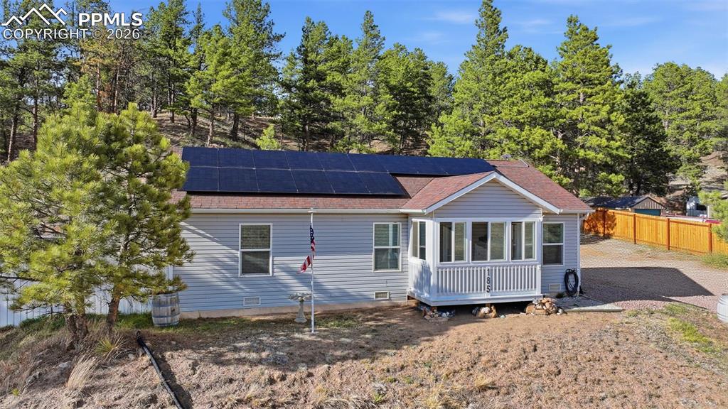 Image 28 of 28: Light gray siding exterior with a red roof
