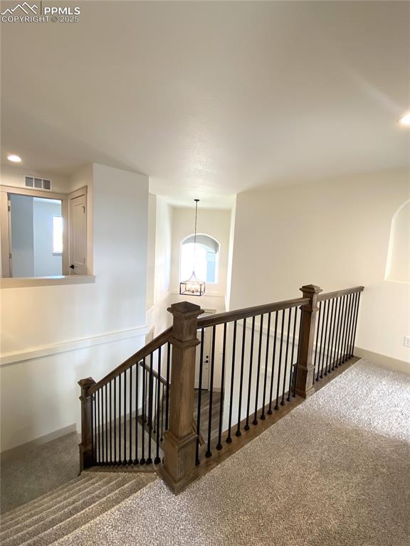 Image 14 of 35: Corridor featuring recessed lighting, carpet flooring, a chandelier, and an