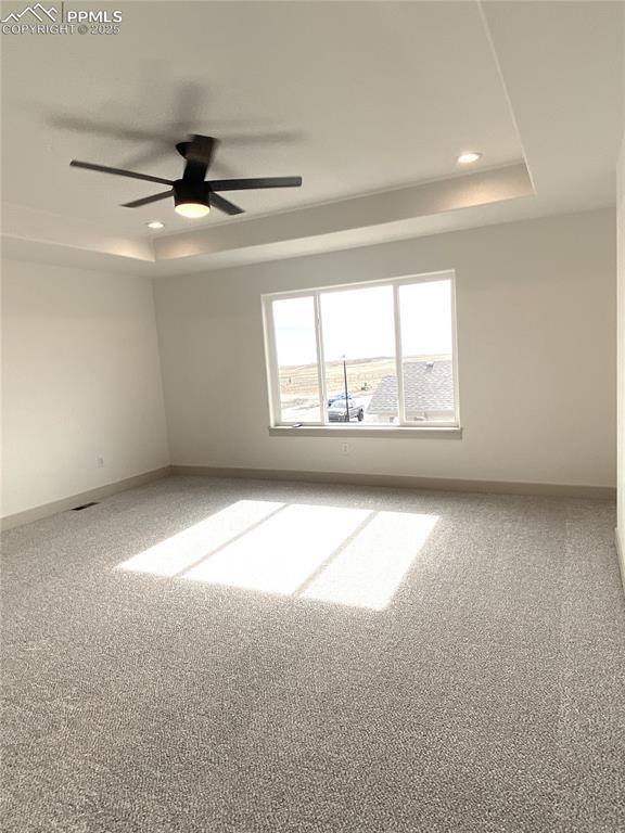 Image 16 of 35: Unfurnished room with a tray ceiling, carpet, recessed lighting, and ceilin