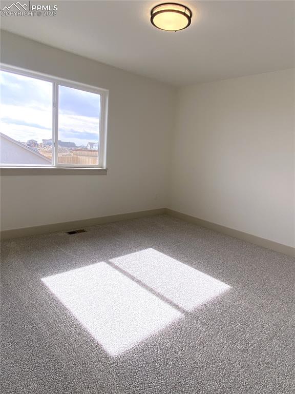 Image 25 of 35: Empty room featuring baseboards and carpet floors