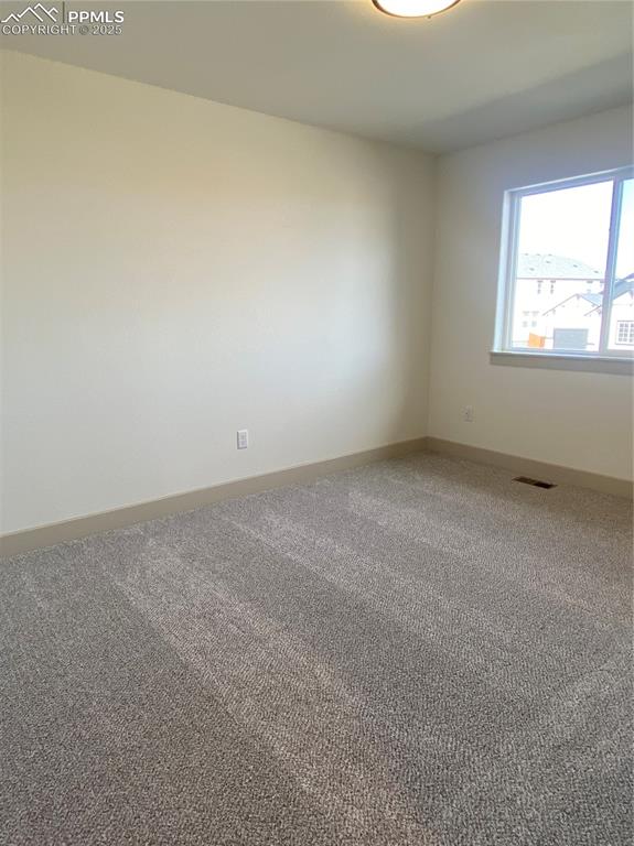 Image 29 of 35: Carpeted empty room with baseboards