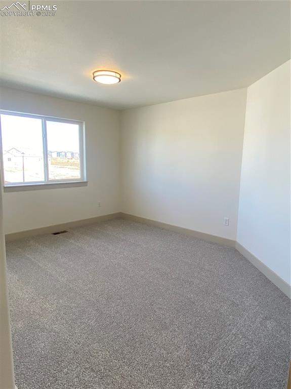 Image 31 of 35: Carpeted empty room featuring baseboards