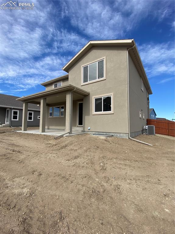 Image 35 of 35: Rear view of house featuring a patio area and stucco siding