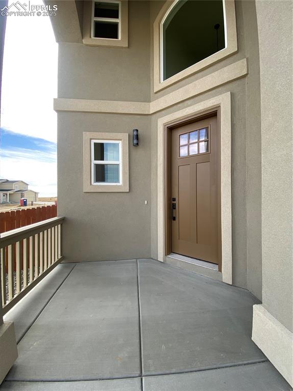 Image 4 of 35: Doorway to property with stucco siding