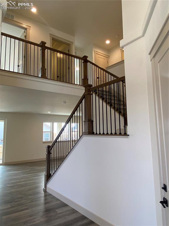 Image 5 of 35: Stairway with recessed lighting and wood finished floors