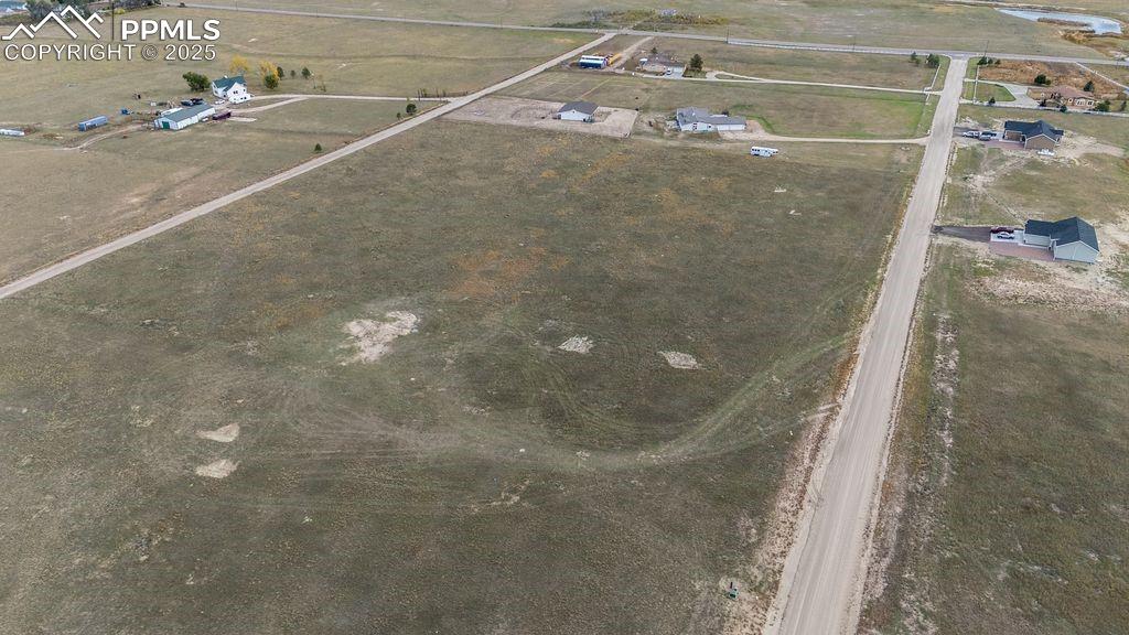 Image 8 of 11: Aerial view of property and surrounding area with rural landscape