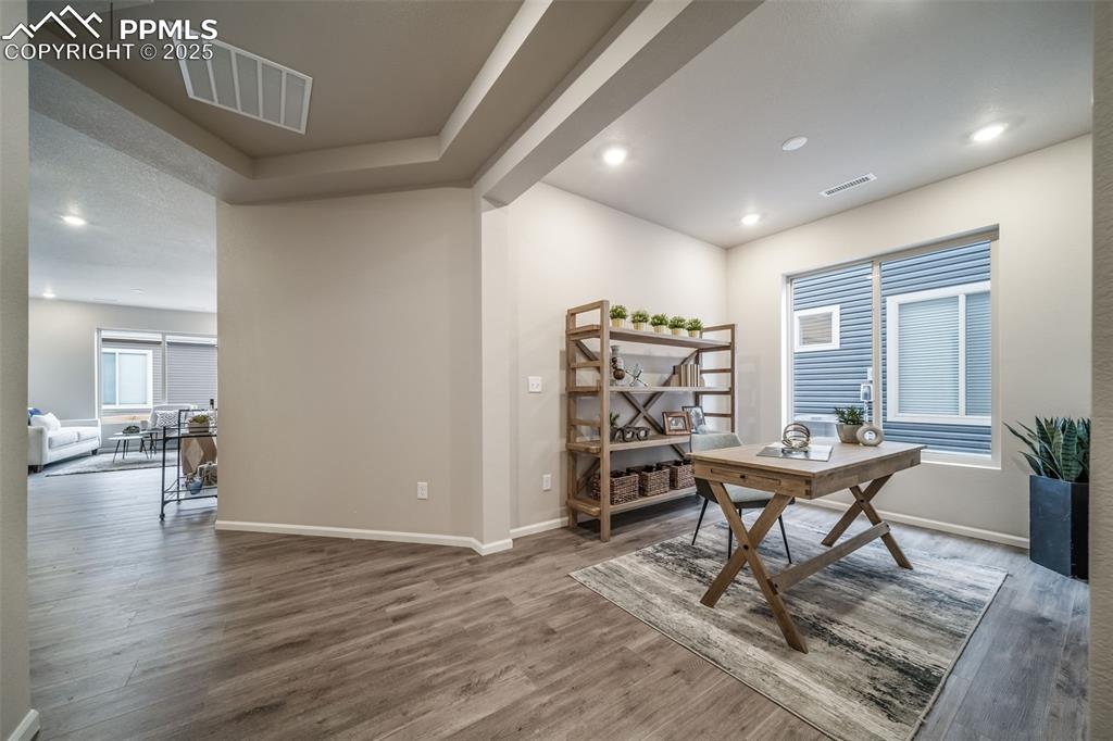 Image 11 of 25: Office area with wood finished floors, recessed lighting, and beam ceiling
