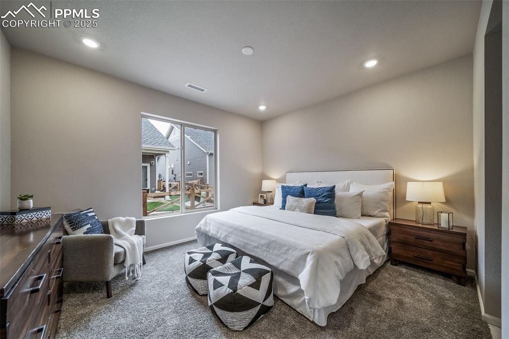 Image 16 of 25: Carpeted bedroom featuring recessed lighting