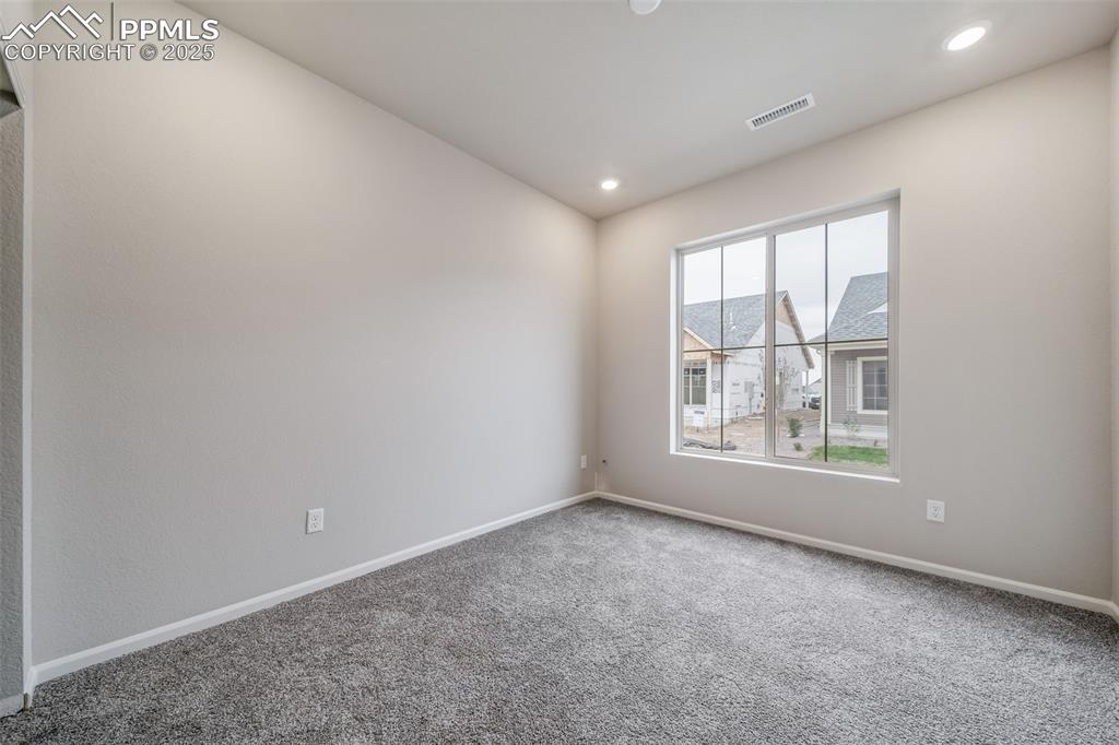 Image 21 of 25: Carpeted empty room featuring baseboards and recessed lighting