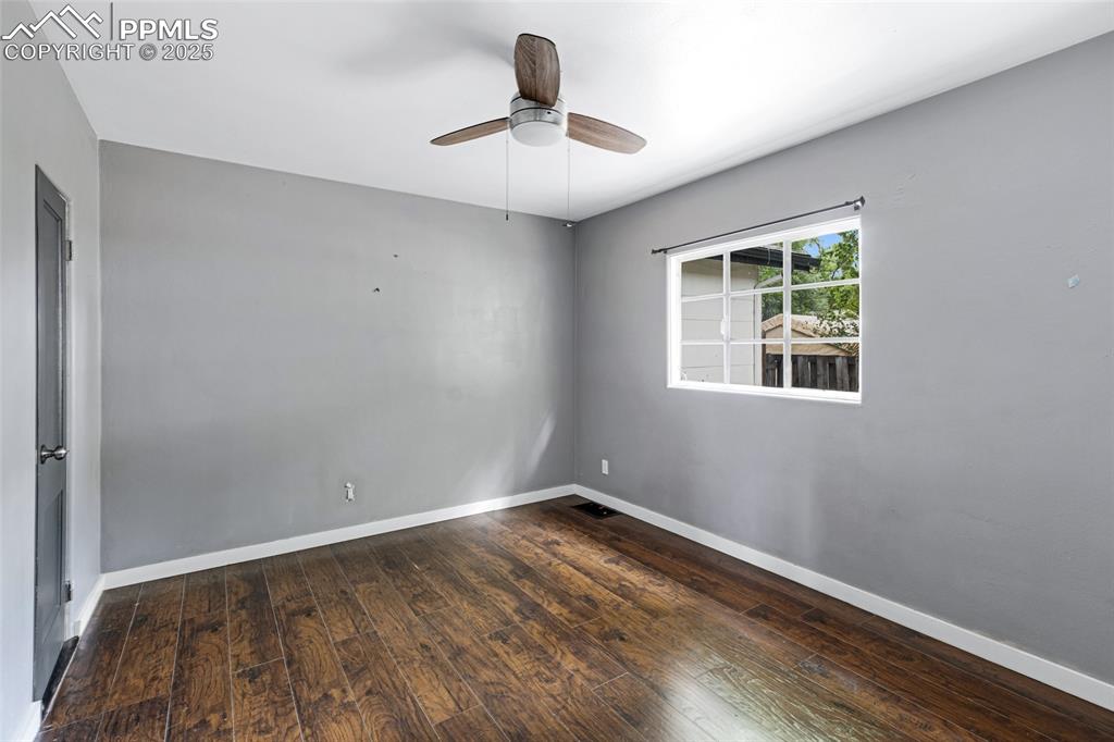 Image 13 of 16: Unfurnished room featuring hardwood / wood-style flooring and a ceiling fan