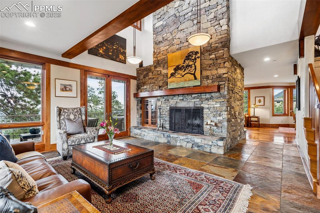 Image 10 of 50: Grand stone fireplace and walk out to the perfect outdoor setting