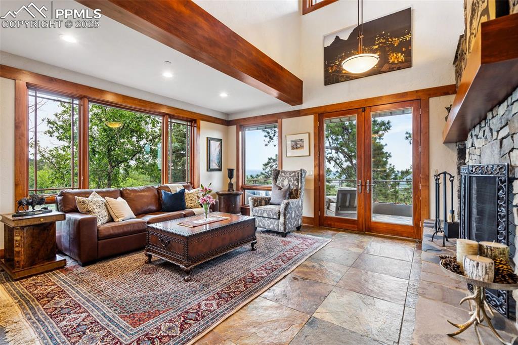 Image 11 of 50: Living room showcasing slate floors and custom woodwork