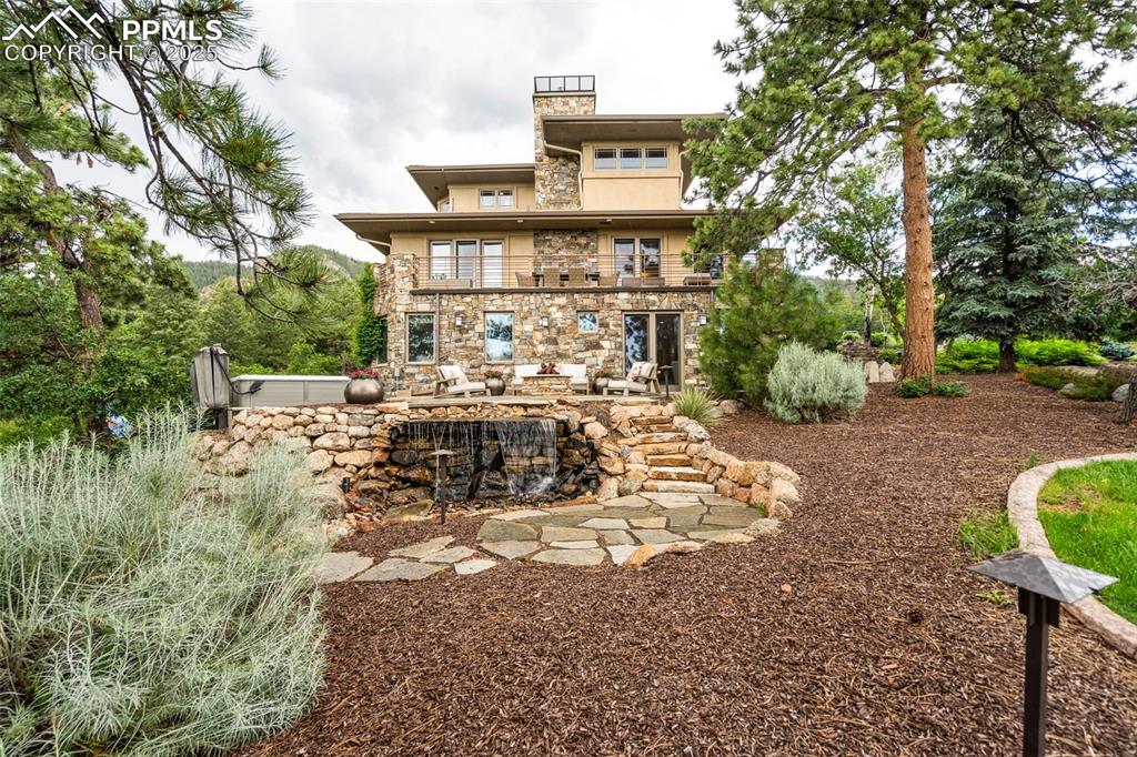 Image 49 of 50: Water feature and hand laid stonework with manicured lawn