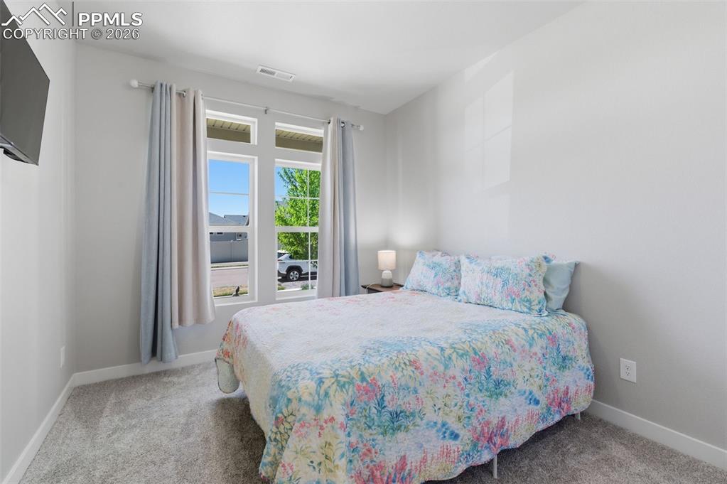 Image 19 of 36: Bedroom by the entry of home