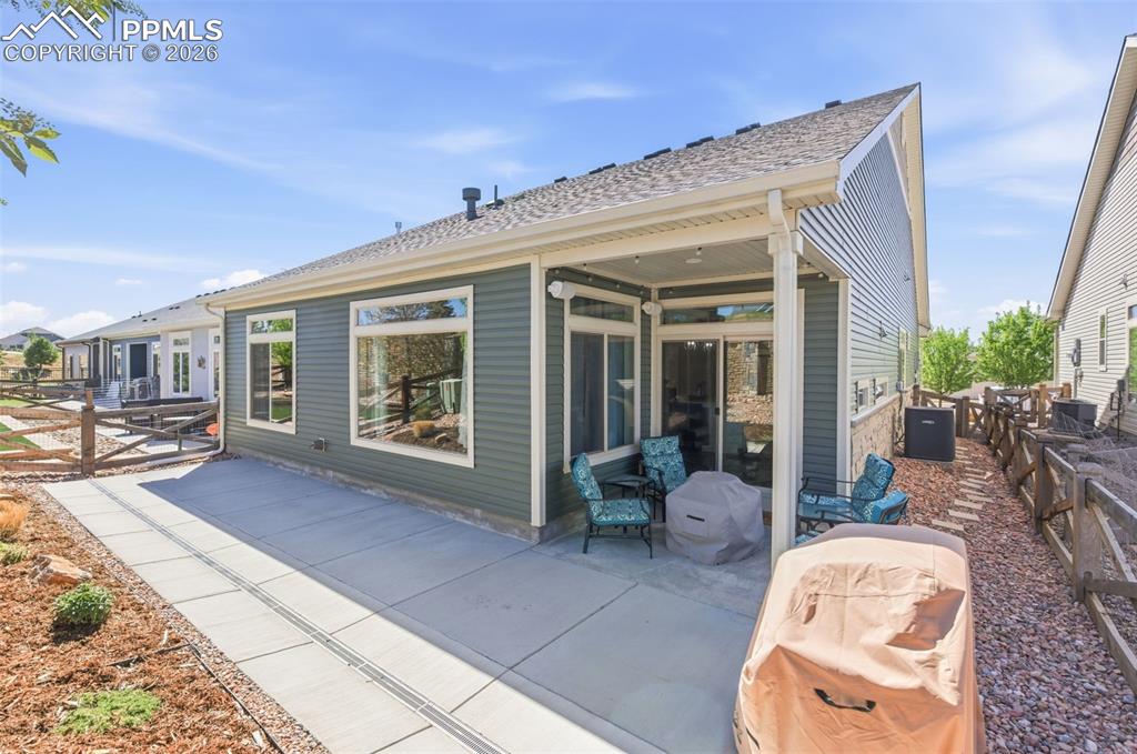 Image 23 of 36: Spacious covered porch and backyard